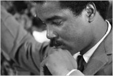 Thumbnail for Norman Lumpkin, news director for WRMA radio, holding a microphone while Martin Luther King, Jr., speaks to a crowd at Maggie Street Baptist Church in Montgomery, Alabama.