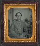 [Unidentified soldier in Confederate uniform in front of painted backdrop showing view from porch; unidentified woman with small child on her lap]