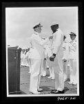 [Untitled photo shows: Admiral Chester W. Nimitz pins the Navy Cross on Doris "Dorie" Miller at a ceremony in Pearl Harbor]