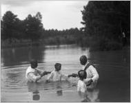 African American woman is baptized.