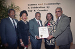 Guy Crowder receiving a commendation from the city at his exhibit, Los Angeles