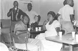 Man and woman seated at a table at Tom's Place at 648 South Holt Street in Montgomery, Alabama.