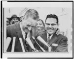 [Thurgood Marshall, head-and-shoulders portrait, behind microphones with Wiley Branton, after court ruling ordering Little Rock schools to proceed with integration]