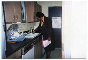 Woman at Sink in Kitchen