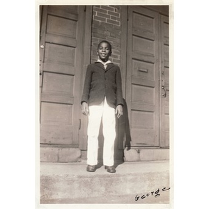 George stands on the stairs of an unidentified church