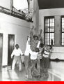 Boys playing basketball in a gymnasium, Marcy Center