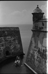 Men navigating through an opening of the fortress, Cartagena, 1975