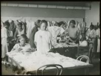 African-American Young Adults Folding Clothes High School