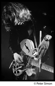 Alvin Lee (guitar, Ten Year After) in performance, Newport Jazz Festival Lee using drumstick as a slide on his guitar