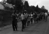 Edward Rudolph leading marchers down an unpaved road in Prattville, Alabama, during a demonstration sponsored by the Autauga County Improvement Association.