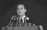 George Wallace speaking on stage at a rally in the Municipal Auditorium in Birmingham, Alabama, during Lurleen Wallace's gubernatorial campaign.