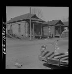 Jacksonville, Florida. Street scene. The car in the foreground belongs to a white car salesman who was canvassing the Negro neighborhood