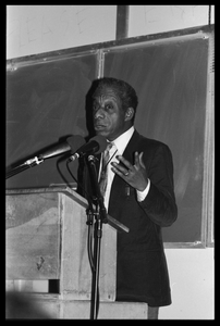 James Baldwin lecturing at UMass Amherst Baldwin standing at a podium with microphones