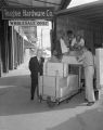 Men unloading boxes of tools at Teague Hardware Company on Commerce Street in Montgomery, Alabama.