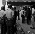 Thumbnail for Police officers and bystanders in front of Social Cleaners across from 16th Street Baptist Church, after the church was bombed.