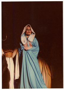 Performance picture of Eartha Kitt (spotlighted) in blue.] [color photoprint