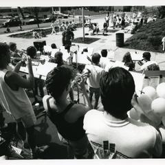 Stout Jazz Band performing outside for students, Memorial Student Center in the background, Spring 1990