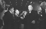 George and Lurleen Wallace walking through a crowd at a rally in the Municipal Auditorium in Birmingham, Alabama, during Lurleen's gubernatorial campaign.