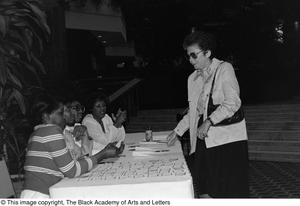 Photograph of five women surrounding a conference table