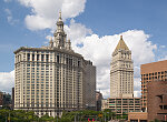 View of the David N. Dinkins Municipal Building in Manhattan, New York City. The 40-story building, completed in 1917, was constructed to accommodate increased governmental space demands after the 1898 consolidation of the city's five boroughs: Manhattan, Brooklyn, Queens, The Bronx, and Staten Island. David Dinkins, New York City's first African-American mayor, served from 1990 to 1993. The tower to the right belongs to the Thurgood Marshall United States Courthouse