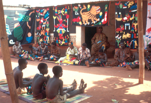 Appliqué workers, in street, Abomey, Benin