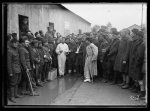 While a crowd of American soldiers are waiting to get into the American Red Cross recreation hut, Base Hospital 114 at Beaudesert near Bordeaux, Lieut. Guy Owsley A.R.C. of Passadena, Cal. stands on a soap box to tell them where and how the American Red Cross Home Service can help them. Oct. 1918