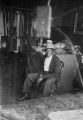 Jasper Wood Collection: Man sitting in front of clothes rack