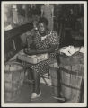 Assembly Street, woman shelling butterbeans under shed, 1946