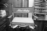 Alex Haley: Seated at bookcase, director's chair (AHP 2-79-10 #64)