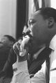 Martin Luther King, Jr., seated during a meeting at Maggie Street Baptist Church in Montgomery, Alabama.