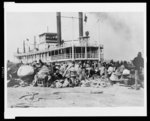 With all their worldly goods--Wrapped in blankets, carrying their most prized possessions, the patient colored folk wait for the Red Cross to rescue them from the levee