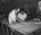 Professor discussing drawings of leaves with a student in a classroom at Tuskegee Institute in Tuskegee, Alabama.