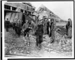 [A starved, almost dead Polish laborer being carried to ambulance by American medics, in a German slave labor camp at Nordhausen, Germany]