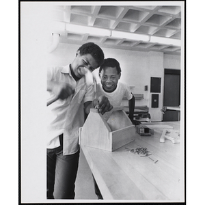 Two Roxbury Boys' Club members working on projects for their woodworking class