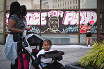 Mary Wyatt, 28, left, stops to look at a mural by graffiti artist known as GirlMobb, beside her two daughters, Zaniyah Wyatt-Moore, 11, and Maryah, 2, in front of the Clorox building in downtown Oakland, Calif., on Thursday, June 4, 2020