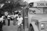 Students getting off Wilcox County school buses at the high school in Pine Hill, Alabama.