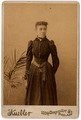 Photograph, African American woman standing beside a plant, [n.d.]