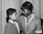 Seafair Queen Adelia Avery with young African-American boy, July 18, 1952