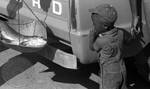 African American boy watching fish getting weighed on scale: Image 2