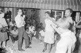 Lula Williams singing on a sidewalk in downtown Montgomery, Alabama, during a civil rights demonstration.