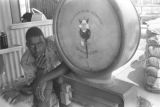 Young man beside a large scale at a cotton gin near Mount Meigs in Montgomery County, Alabama.