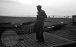 African American man carrying fishing gear