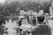 Protestors, police officers, and Klansmen at a United Klans of America march in Mobile, Alabama.