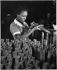 "Bertha Stallworth, age 21, shown inspecting end of 40mm artillery cartridge case at Frankford Arsenal."