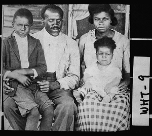 Postcard of L. O. Cleveland and family on porch of their home, Cleveland, White County, Georgia, ca. 1921