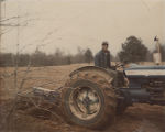 Albert "Peter" Datcher driving a tractor on the family farm in Harpersville, Alabama.