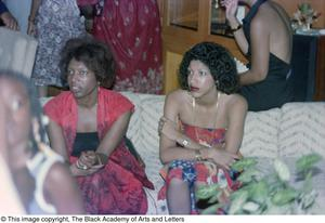 Photograph of two women sitting on a sofa