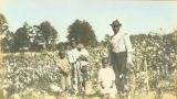 Albert Griffin with his children in a cotton field in Wilcox County, Alabama.