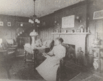 Meta Warrick Fuller in her living room on Warren Drive, Framingham, Massachusetts. "Four Seasons" sculpture over mantle in fireplace