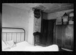 Typical bedroom in Negro slum, Washington, D.C. A bed, one chair, and a possible bit of furniture for a bureau is usually the most such a bedroom can boast. Filth and vermin are as characteristic of this type of dwelling as the falling plaster shown here